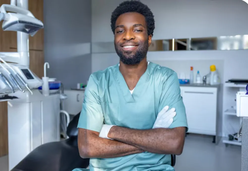 Friendly dentist in scrubs in a modern dental clinic